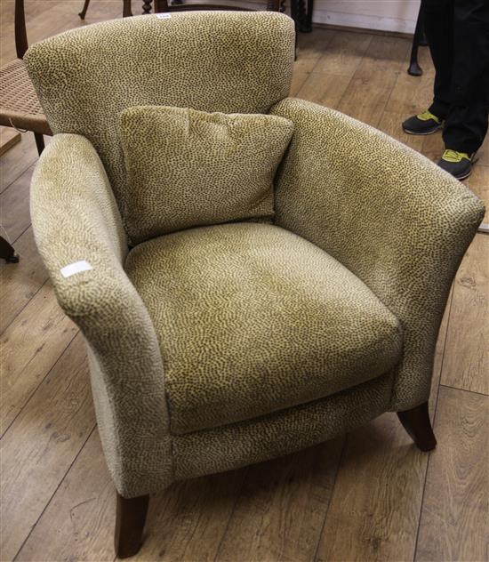 A tub chair with simulated fur upholstery